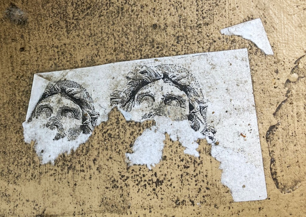 a ripped sticker of two faces