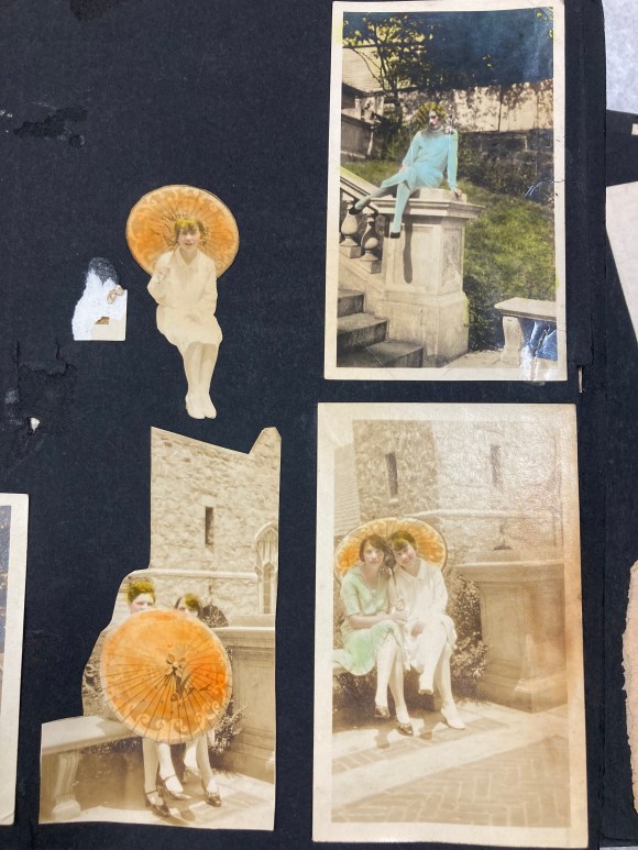 Scrapbook page from the 1920s with hand-tinted photos of a woman with a parasol